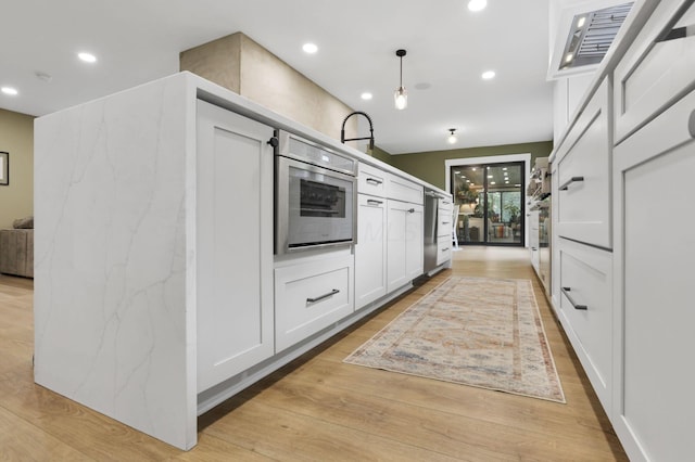 29 Pocono Rd, Columbus, OH 43235 - kitchen featuring white cabinets, light wood finished floors, recessed lighting, and decorative light fixtures