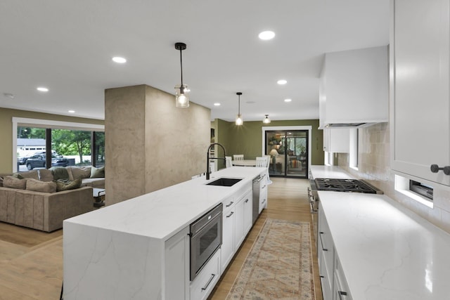 29 Pocono Rd, Columbus, OH 43235 - kitchen featuring a sink, stainless steel appliances, recessed lighting, white cabinetry, and open floor plan