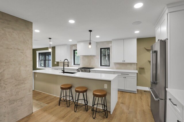29 Pocono Rd, Columbus, OH 43235 - kitchen with high quality fridge, a sink, a breakfast bar area, white cabinets, and light wood-style floors