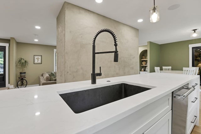 29 Pocono Rd, Columbus, OH 43235 - kitchen with a sink, light stone countertops, white cabinetry, dishwasher, and pendant lighting