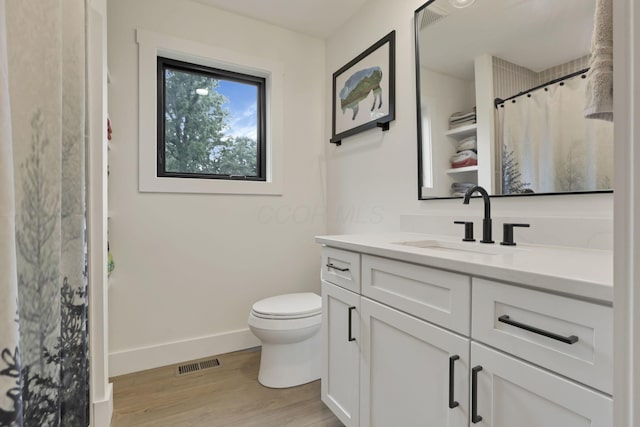 29 Pocono Rd, Columbus, OH 43235 - bathroom featuring vanity, wood finished floors, toilet, baseboards, and curtained shower