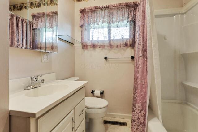 1270 Wetsell Ave, Lancaster, OH 43130 - bathroom featuring vanity, toilet, shower / tub combo with curtain, baseboards, and tile patterned floors