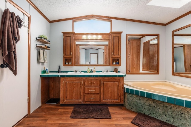 2389 Bluff Run Dr, Grove City, OH 43123 - full bathroom with wood finished floors, double vanity, a garden tub, a textured ceiling, and ornamental molding