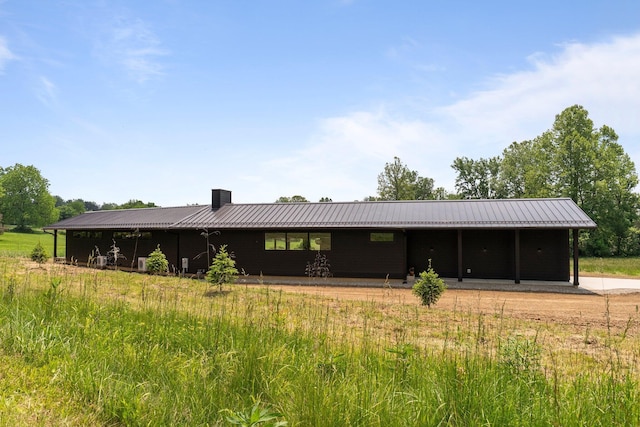 7931 Concord Rd, Johnstown, OH 43031 - rear view of house featuring a metal roof and a chimney