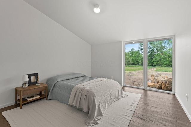 7931 Concord Rd, Johnstown, OH 43031 - bedroom with lofted ceiling, wood finished floors, and access to exterior