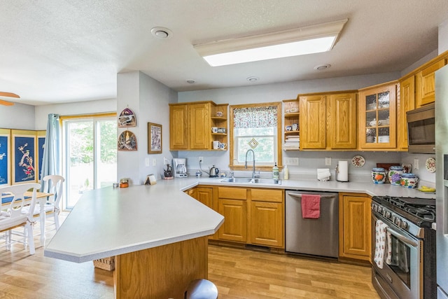5971 Weaver Rd, Conneaut, OH 44030 - kitchen featuring stainless steel appliances, a sink, a peninsula, open shelves, and light countertops