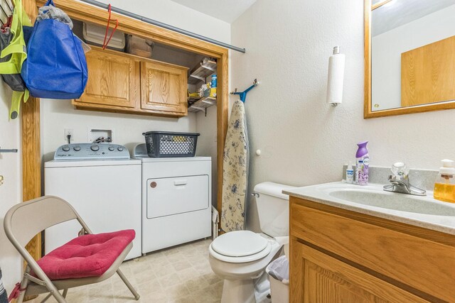5971 Weaver Rd, Conneaut, OH 44030 - bathroom with independent washer and dryer, vanity, toilet, and tile patterned floors