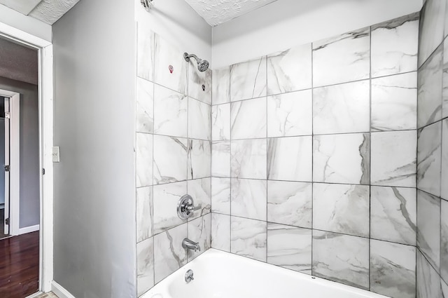 1011 Mcclelland Ave, Columbus, OH 43211 - bathroom featuring tub / shower combination and a textured ceiling