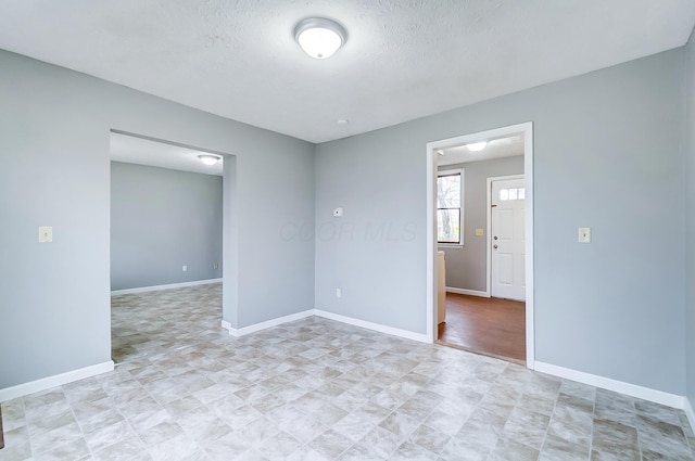1011 Mcclelland Ave, Columbus, OH 43211 - spare room featuring baseboards and a textured ceiling