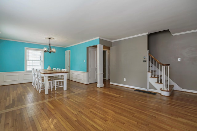 966 Chambers Cir, Columbus, OH 43212 - dining space with hardwood / wood-style floors, a chandelier, wainscoting, a decorative wall, and crown molding