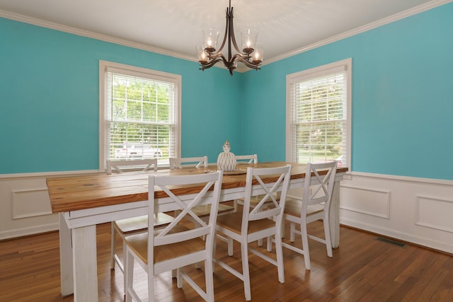 966 Chambers Cir, Columbus, OH 43212 - dining area featuring wainscoting, a chandelier, crown molding, wood finished floors, and a decorative wall