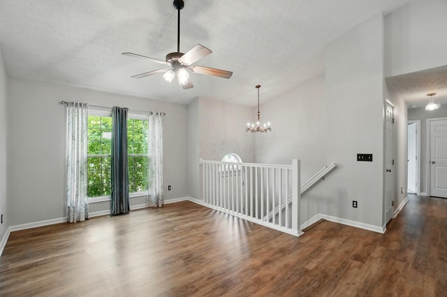 418 Broadview Ct, Pataskala, OH 43062 - spare room with a textured ceiling, ceiling fan, wood finished floors, baseboards, and a chandelier