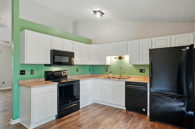 418 Broadview Ct, Pataskala, OH 43062 - kitchen with black appliances, a sink, light countertops, white cabinetry, and light wood-style floors
