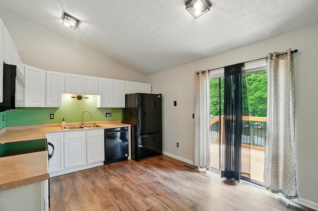 418 Broadview Ct, Pataskala, OH 43062 - kitchen with black appliances, a sink, light countertops, lofted ceiling, and a textured ceiling