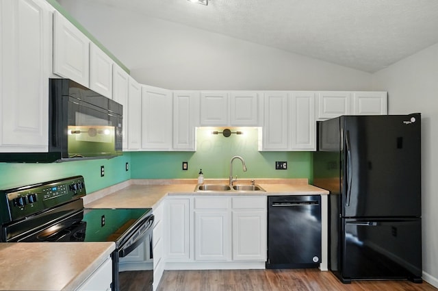 418 Broadview Ct, Pataskala, OH 43062 - kitchen with black appliances, lofted ceiling, a sink, white cabinets, and light countertops