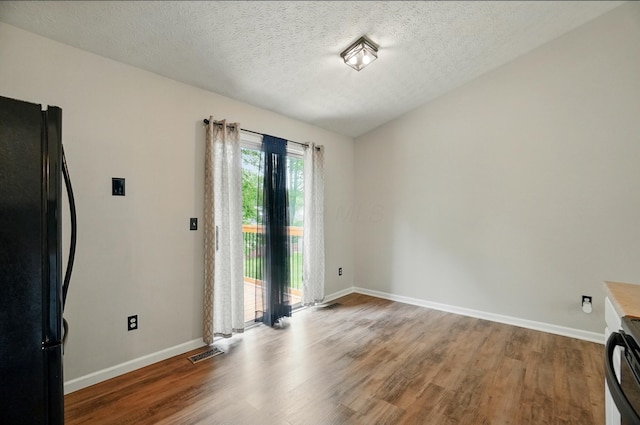 418 Broadview Ct, Pataskala, OH 43062 - unfurnished dining area featuring wood finished floors, baseboards, and a textured ceiling