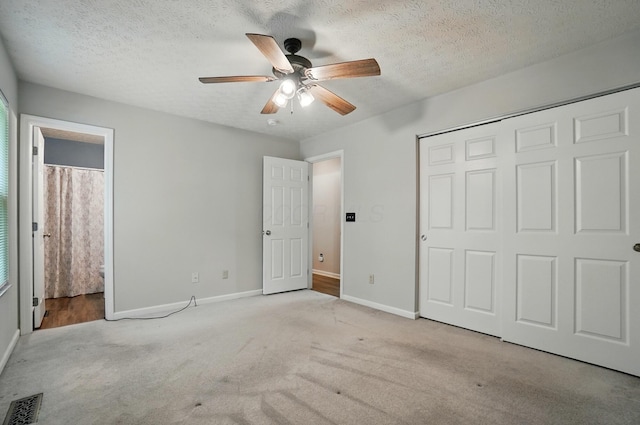 418 Broadview Ct, Pataskala, OH 43062 - unfurnished bedroom with carpet, baseboards, a closet, connected bathroom, and a textured ceiling