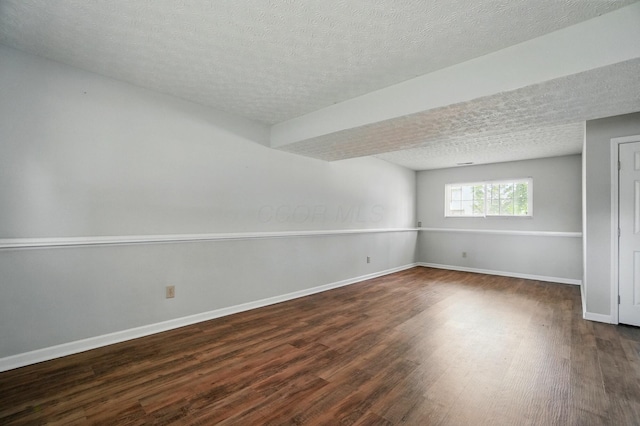 418 Broadview Ct, Pataskala, OH 43062 - unfurnished room featuring dark wood finished floors, a textured ceiling, and baseboards