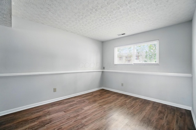 418 Broadview Ct, Pataskala, OH 43062 - unfurnished room with wood finished floors, a textured ceiling, and baseboards