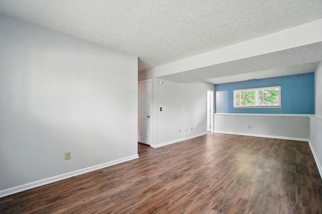 418 Broadview Ct, Pataskala, OH 43062 - empty room featuring dark wood-style flooring, a textured ceiling, and baseboards