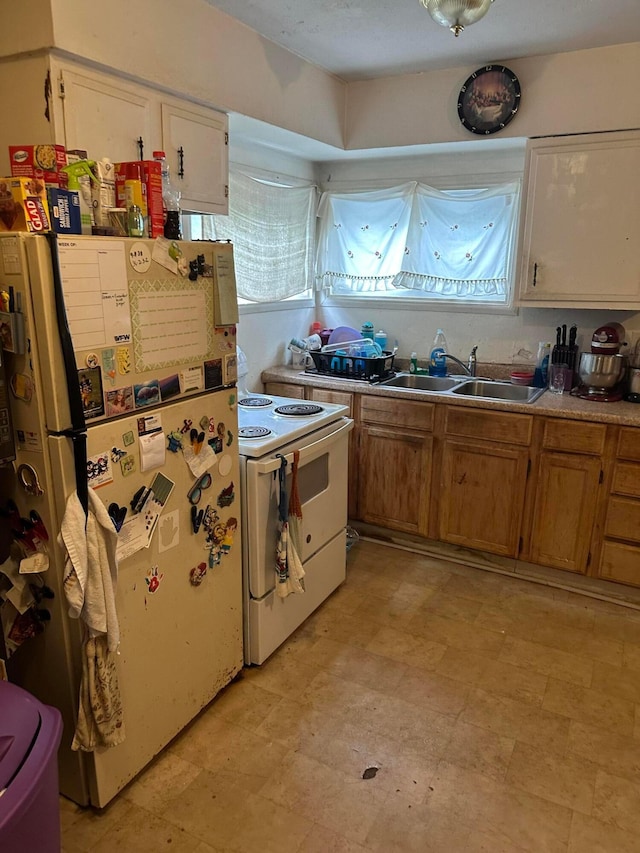 803 Demorest Rd, Columbus, OH 43204 - kitchen featuring white appliances, a sink, healthy amount of natural light, and light countertops