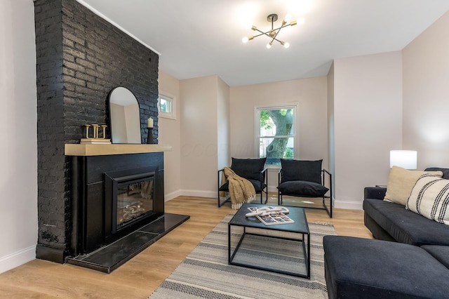 72 Avondale Ave, Columbus, OH 43222 - living area featuring a chandelier, a fireplace, and light wood finished floors