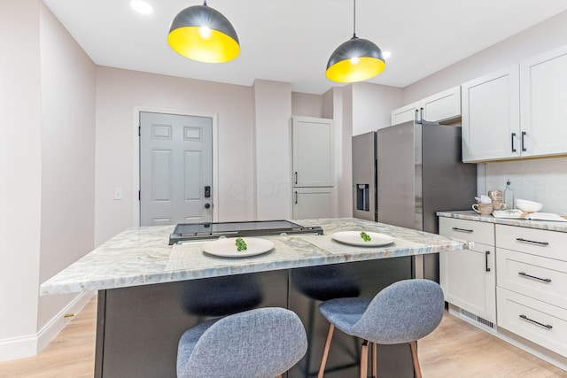 72 Avondale Ave, Columbus, OH 43222 - kitchen featuring a kitchen breakfast bar, light wood finished floors, white cabinets, and a kitchen island