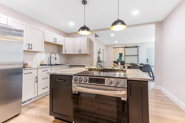 72 Avondale Ave, Columbus, OH 43222 - kitchen featuring stainless steel appliances, white cabinets, light wood-style floors, backsplash, and recessed lighting