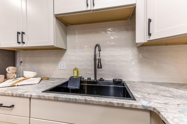 72 Avondale Ave, Columbus, OH 43222 - kitchen featuring white cabinets, tasteful backsplash, and light stone countertops