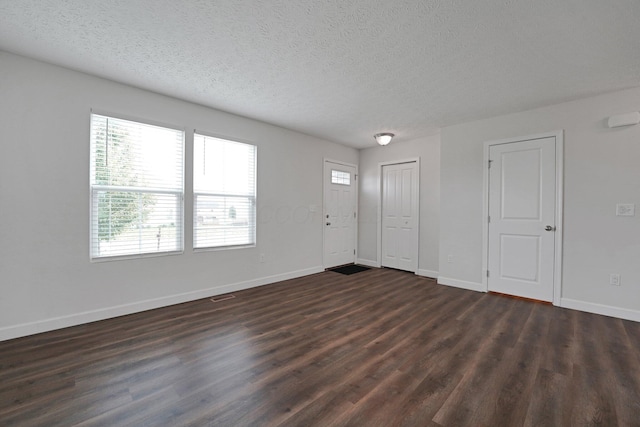 2576 Brook Run Dr, Lancaster, OH 43130 - foyer entrance featuring dark wood-style flooring, a textured ceiling, and baseboards