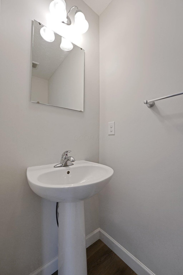 2576 Brook Run Dr, Lancaster, OH 43130 - bathroom with baseboards, a sink, and wood finished floors