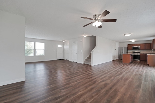 2576 Brook Run Dr, Lancaster, OH 43130 - unfurnished living room with baseboards, stairs, dark wood finished floors, and ceiling fan