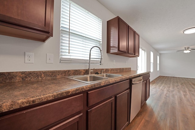 2576 Brook Run Dr, Lancaster, OH 43130 - kitchen with a sink, stainless steel dishwasher, dark countertops, and wood finished floors