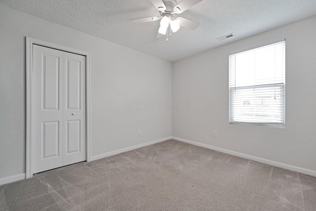 2576 Brook Run Dr, Lancaster, OH 43130 - unfurnished bedroom featuring carpet, a textured ceiling, a closet, baseboards, and ceiling fan