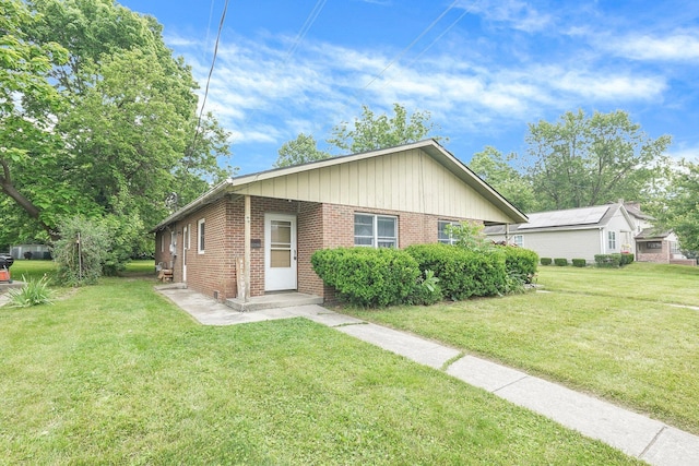 66-64 Eaton St, Delaware, OH 43015 - view of front of home with brick siding and a front yard