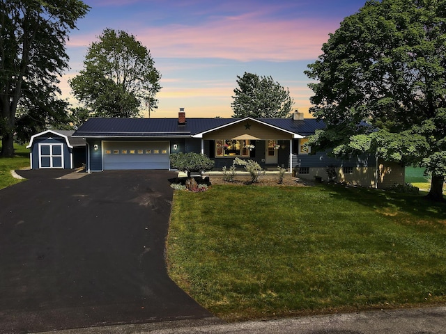 4476 Stiving Rd, Shelby, OH 44875 - ranch-style house featuring a chimney, an attached garage, and a front lawn