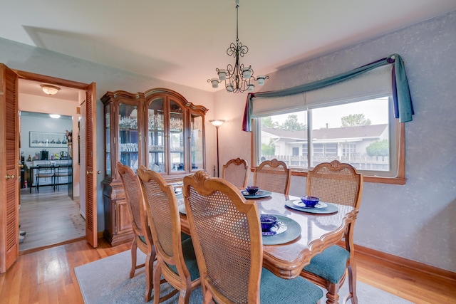 4909 Vanlear Rd, Columbus, OH 43229 - dining space with light wood-type flooring, a chandelier, and baseboards