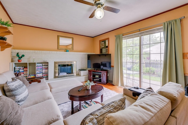 4909 Vanlear Rd, Columbus, OH 43229 - living room featuring a fireplace, crown molding, ceiling fan, and wood finished floors
