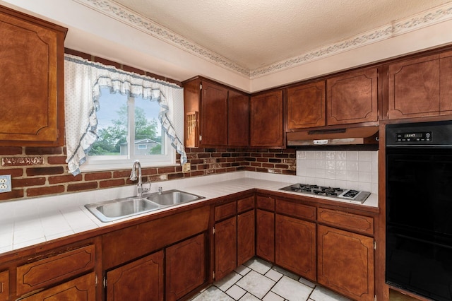 5045 Labelle Dr, Columbus, OH 43232 - kitchen featuring tile countertops, a sink, stainless steel gas stovetop, decorative backsplash, and under cabinet range hood