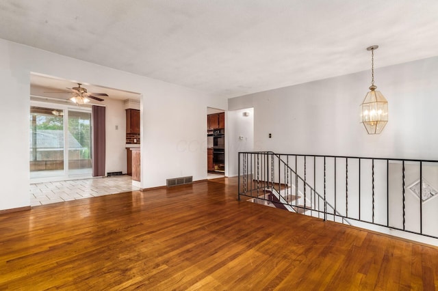 5045 Labelle Dr, Columbus, OH 43232 - unfurnished room featuring wood finished floors, a chandelier, ceiling fan, and baseboards