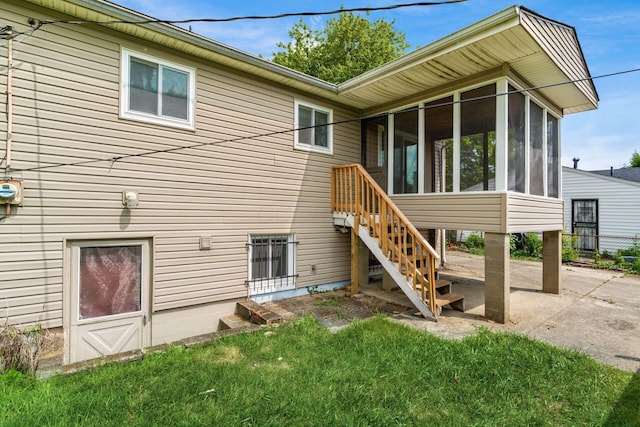 5045 Labelle Dr, Columbus, OH 43232 - rear view of property with a sunroom, a patio area, a yard, and stairway