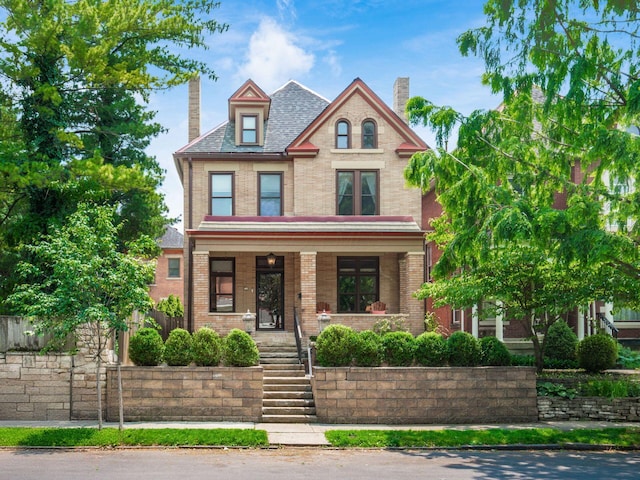 471 W 4th Ave, Columbus, OH 43201 - victorian home featuring brick siding, covered porch, and a chimney