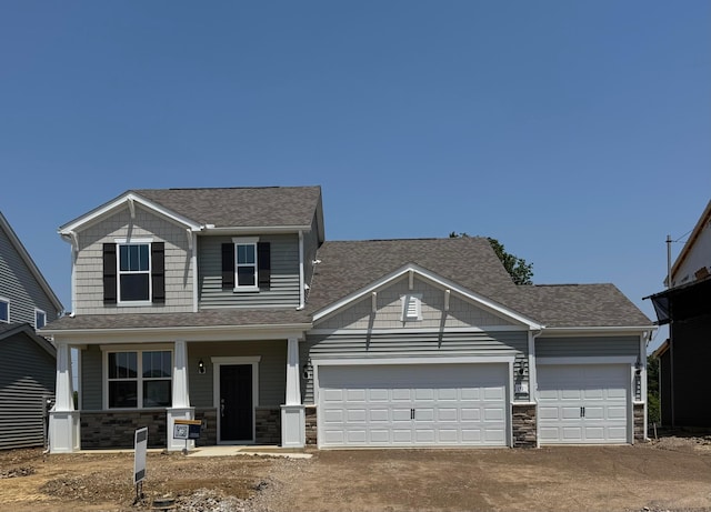 1518 Crest Dr Lot 2527, Galena, OH 43021 - craftsman-style home featuring a shingled roof, a garage, stone siding, driveway, and covered porch