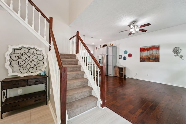 5191 Hialeah Ct, Columbus, OH 43221 - staircase featuring a ceiling fan, wood finished floors, and a textured ceiling