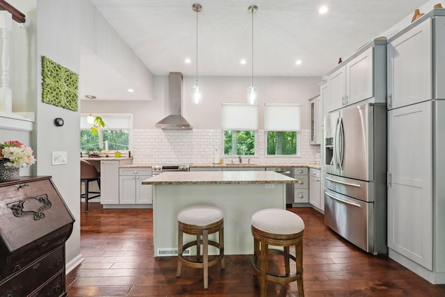 5191 Hialeah Ct, Columbus, OH 43221 - kitchen with wall chimney exhaust hood, stainless steel appliances, a sink, dark wood-type flooring, and a kitchen breakfast bar