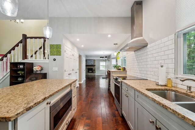 5191 Hialeah Ct, Columbus, OH 43221 - kitchen featuring stainless steel appliances, healthy amount of natural light, extractor fan, dark wood-style flooring, and recessed lighting