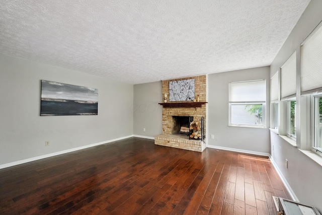 5191 Hialeah Ct, Columbus, OH 43221 - unfurnished living room featuring a textured ceiling, hardwood / wood-style floors, a fireplace, and baseboards