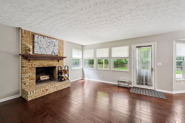 5191 Hialeah Ct, Columbus, OH 43221 - unfurnished living room with a textured ceiling, a fireplace, wood-type flooring, and baseboards
