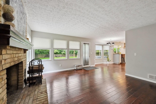 5191 Hialeah Ct, Columbus, OH 43221 - living area featuring a chandelier, baseboards, a fireplace, a textured ceiling, and wood finished floors