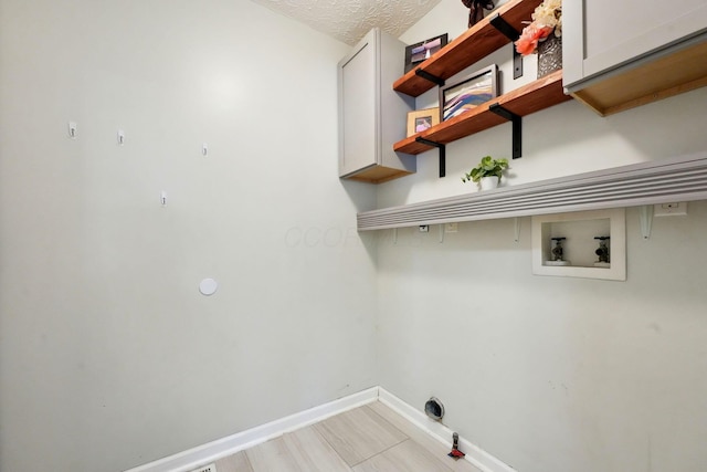 5191 Hialeah Ct, Columbus, OH 43221 - laundry room featuring washer hookup, cabinet space, baseboards, gas dryer hookup, and a textured ceiling